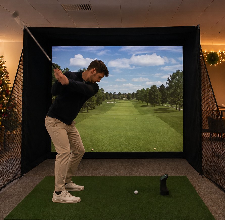 Golfer mid-swing on the Teed Up simulator set up in an office breakout area decorated for Christmas