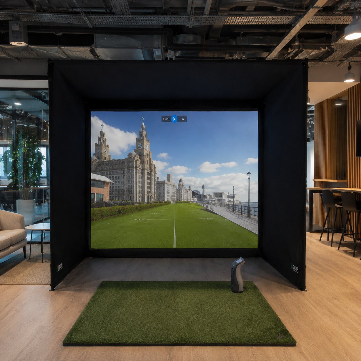 Teed Up golf simulator in a Liverpool office, playing a golf hole along the Pier Head with the Royal Liver Building on the impact screen